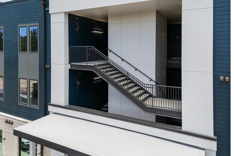 The open exterior stair and covered breezeway between the residences