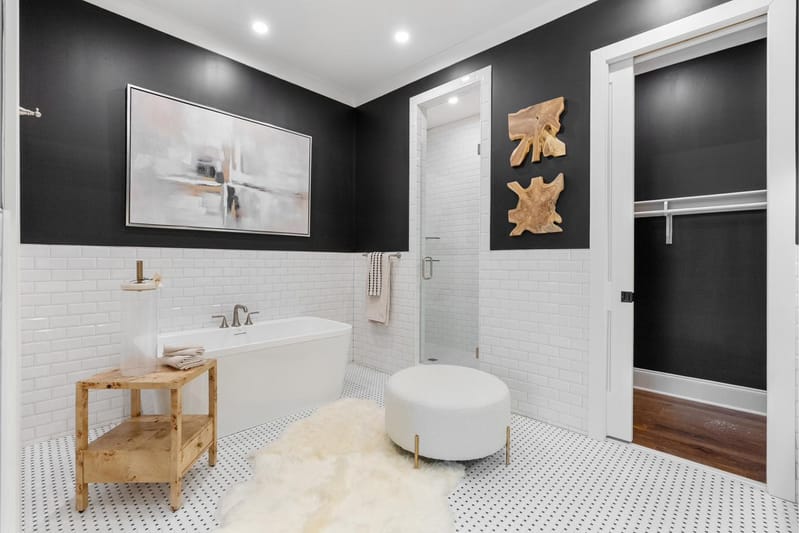 Primary bath with a freestanding tub, glass shower, and two closets