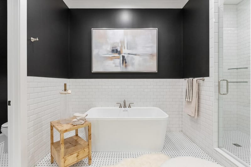 Primary bath with a freestanding tub, subway tile, and a glass shower