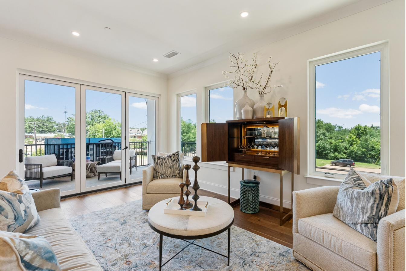 Living room at The Breakaway Oxford with folding glass doors open to the covered porch